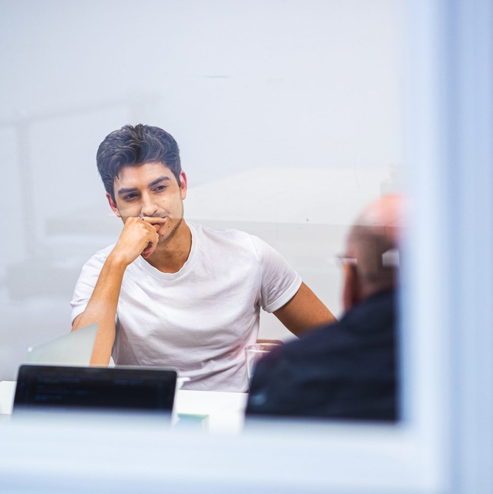 Jason in a meeting with team members