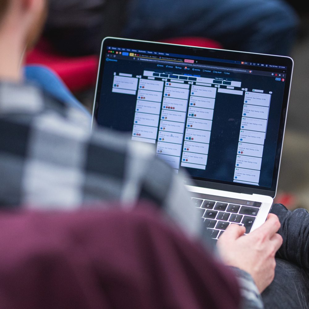 a laptop viewed from over a team members shoulder