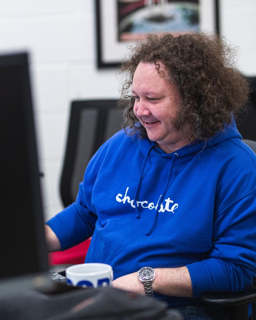 joe happily working at a computer